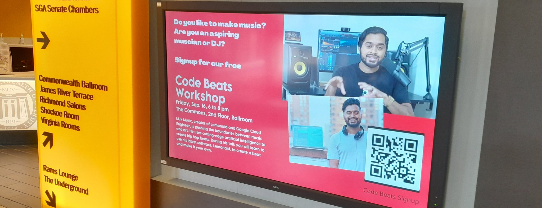 A poster on a TV screen presenting the next code beats workshop.
